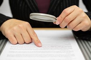 Title Insurance Underwriter closely looking for clerical errors