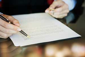 man at home title company reviewing title documents