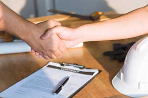 people shaking hands after knowing do i need owner's title insurance for new construction