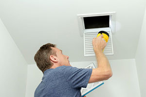 Man looking at air ducts