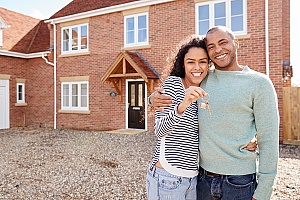 a couple holding keys to new house after finding out what is a Purchase Agreement 