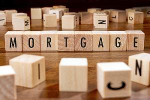 Mortgage written on wooden blocks. Concept image for fixed rate mortgage