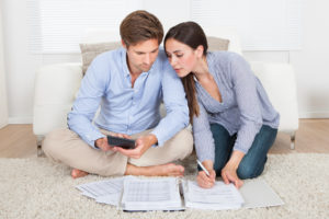 couple are calculating the cost and How To Get Rid Of PMI