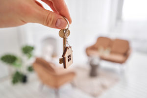 homebuyer holds key to new home after reaching commitment to buy house and the title insurance