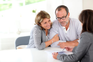 broker explains the refinancing options to the couple
