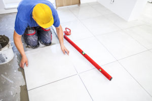 contractor puts the tile in place after coming to an agreement with homeowner on the mechanics lien