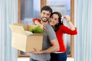 the first time home buyers smile as they move into their new home