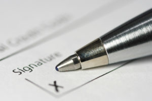 upclose view of a signature line on a title company contract
