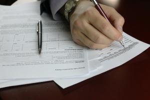 person signing a form for title company