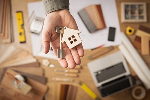 real estate agent handing over a house key with Owner's Title Insurance