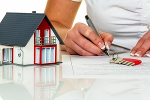 a woman signs a purchase agreement for a house in a real estate agent in the Mortgage Industry