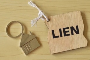 property lien concept with home keychain