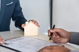Person reviewing title insurance policy terms before signing the document