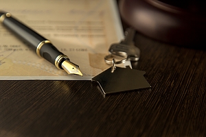rental contract. A rental agreement / lease document with keys and pen.Keys on the signed contract of purchase and sale of the house and the handle
