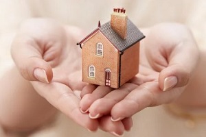 women holding miniature home